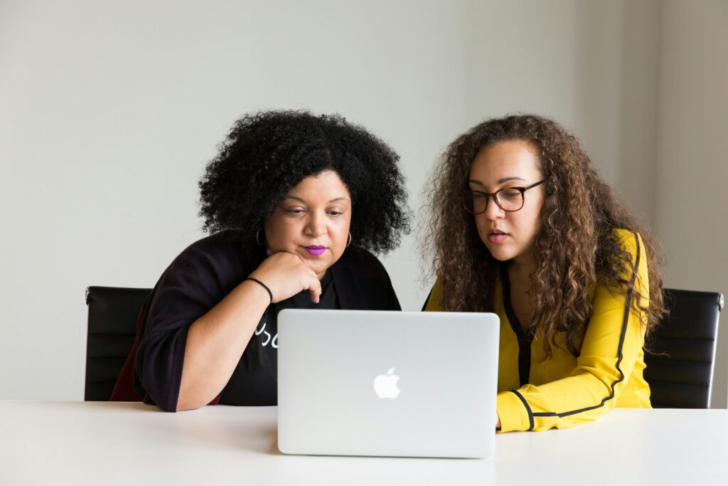 Women Using Laptop - Best Prop Firm for Options Trading