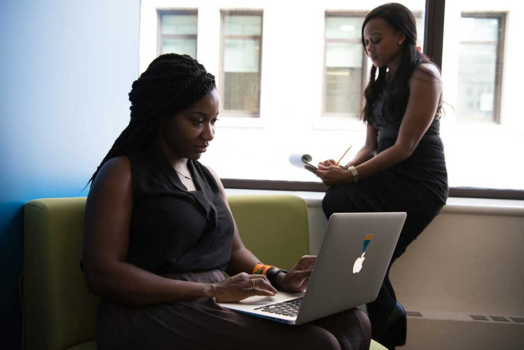 woman on a laptop - Futures Swing Trading Prop Firm		
