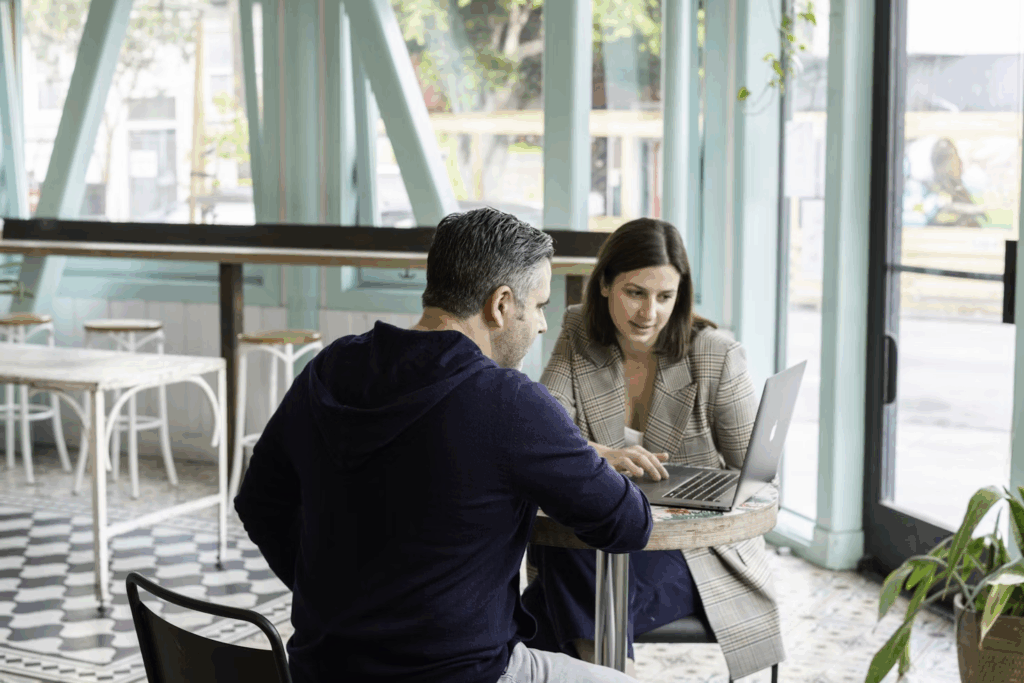 man and woman on a laptop - Equity Prop Trading Firms	
