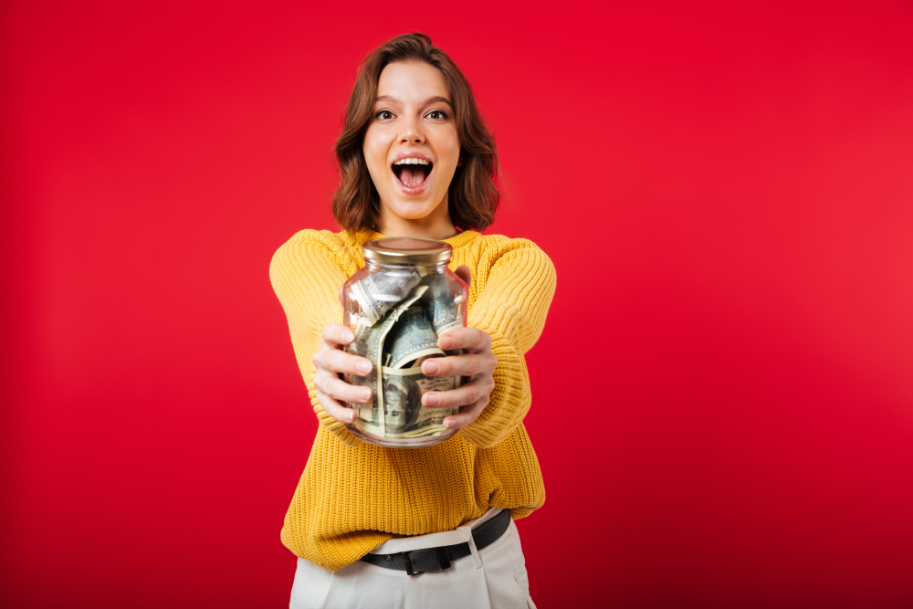 woman holding a jar of money - How to Flip Money