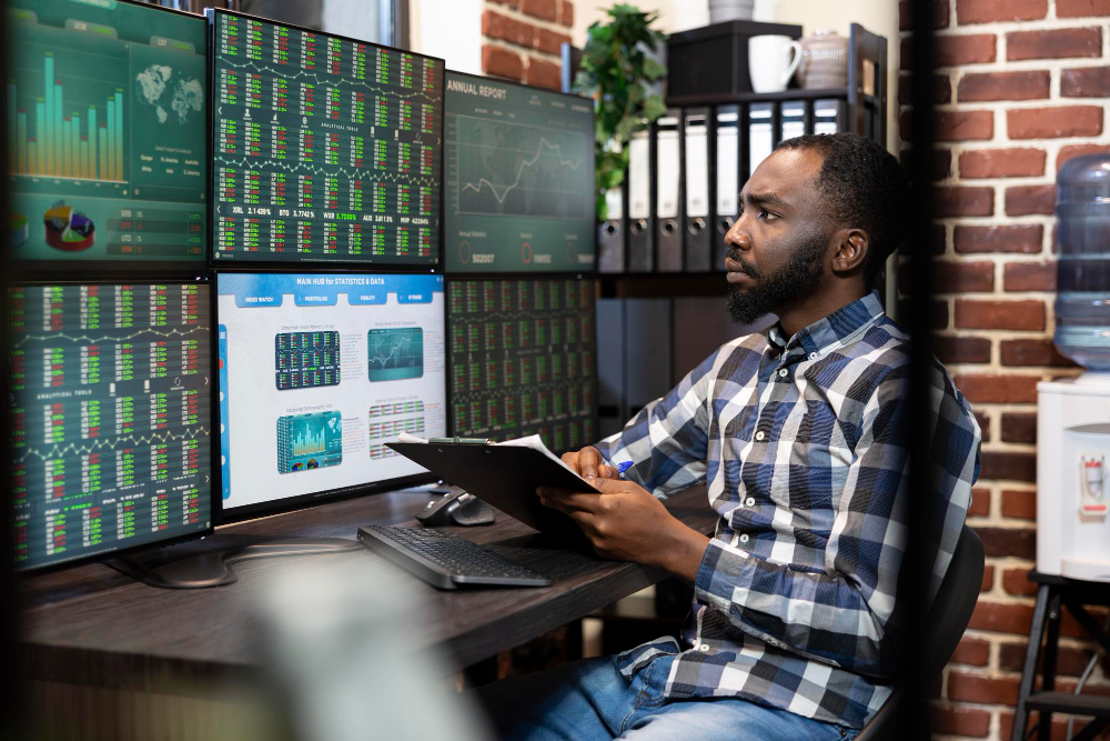 man trading on multiple screens - How Old Do You Have to Be to Start Trading