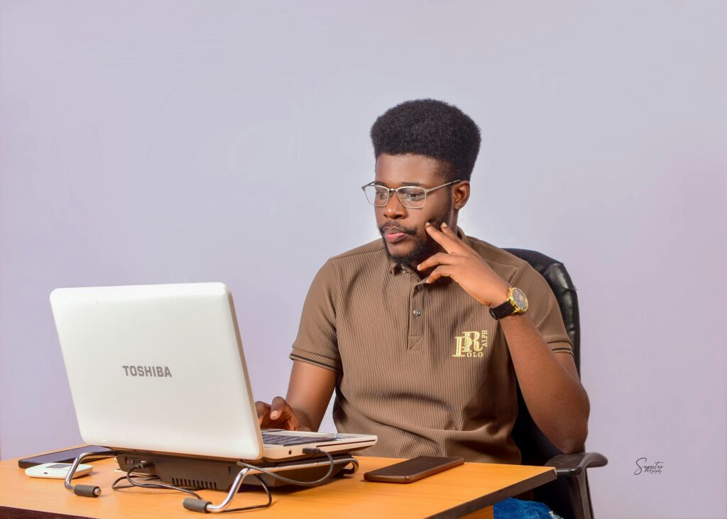 man looking at a laptop - Is Swing Trading Better Than Day Trading