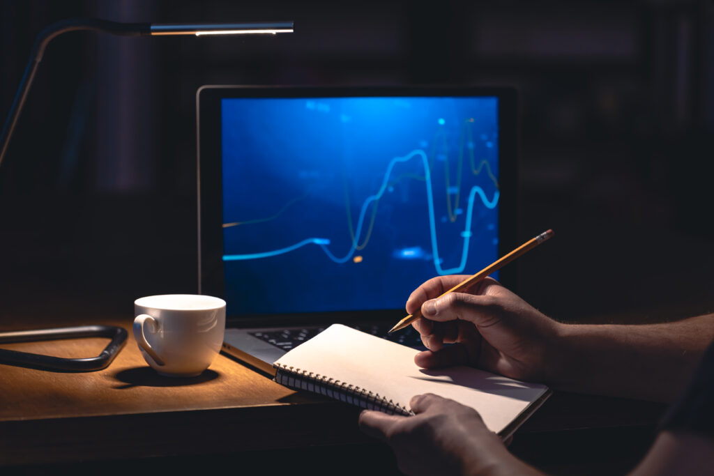 man writing and trading - Simple Trading Strategy